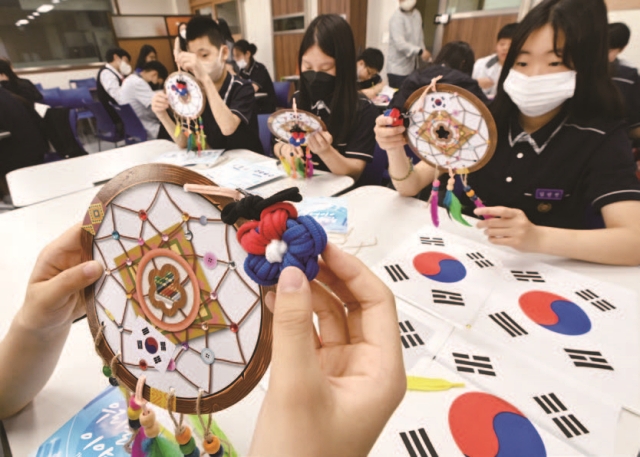 5월 19일 경기동부보훈지청 주최로 성남시 서현중학교에서 열린 호국보훈 체험활동 &lsquo;우리들의 이야기&rsquo; 행사에서 학생들이 국가유공자들에게 감사한 마음을 담아 &lsquo;태극 드림캐처 만들기&rsquo;와 &lsquo;무궁화 컬러링 엽서쓰기&rsquo;를 하고 있다. 사진 뉴시스