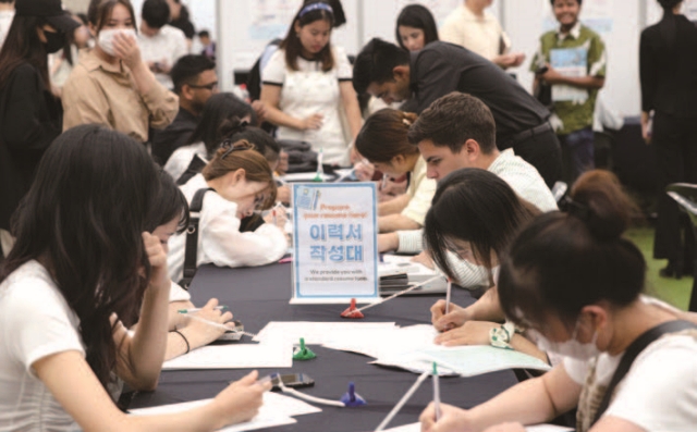 7월 20일 부산항국제전시컨벤션센터에서 열린 ‘지역특화형 비자 유학생 채용박람회’에서 외국인 유학생들이 이력서를 작성하고 있다. 사진 뉴시스