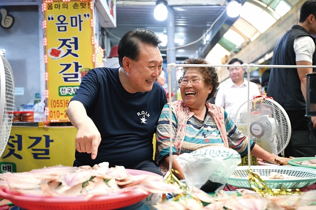 윤석열 대통령이 여름휴가 첫날인 8월 5일 경남 통영중앙전통시장을 찾아 상인과 대화를 나누고 있다. 사진 대통령실
