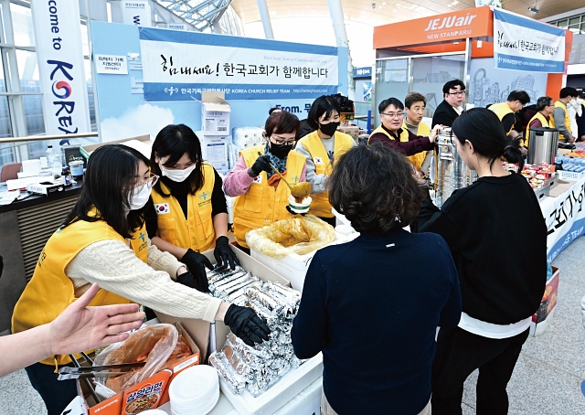제주항공 여객기 사고 발생 사흘째인 2024년 12월 31일 전남 무안국제공항에서 자원봉사단체 회원들이 구호물품을 나누고 있다. 사진 뉴시스