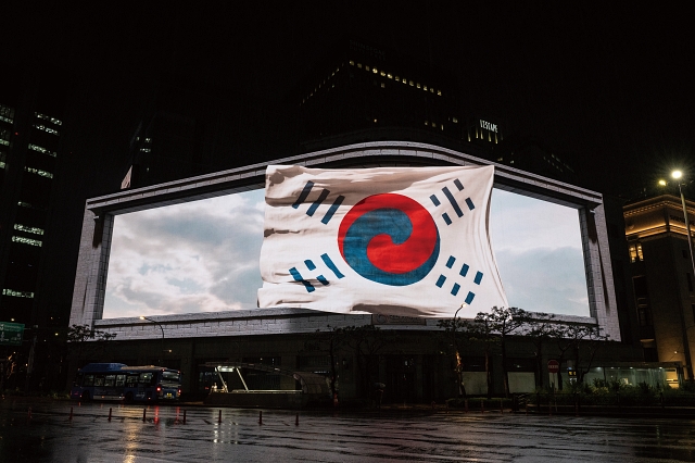 광복 80주년을 맞아 디지털로 재탄생한 '데니 태극기' 실감 콘텐츠 영상이 서울 명동 신세계스퀘어에서 상영되고 있는 모습. 사진 국립중앙박물관