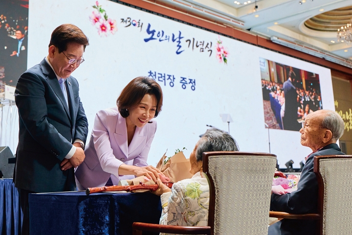 이재명 대통령과 김혜경 여사가 10월 2일 서울의 한 호텔에서 열린 제30회 노인의 날 기념식에 참석해 100세 어르신들께 건강과 장수를 기원하는 뜻을 담은 지팡이인 &lsquo;청려장&rsquo;을 전달하고 있다. 사진 청와대