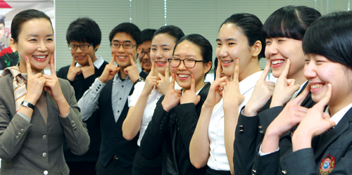 지난 1월 26일 서울 강서구 오쇠동 아시아나타운에서 열린 ‘글로벌 매너 스쿨’에서 참가자들이 미소짓는 연습을 하고 있다. 이 행사는 아시아나항공이 고졸 취업 준비생들을 위해 개최한 것이다.