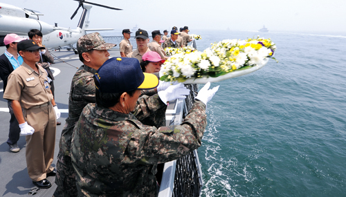 지난 6월 14일 제2연평해전 10주기를 보름 앞두고 한국 최초의 스텔스 구축함 문무대왕함에 탑승한 유가족들이 해상헌화를 하고 있다.