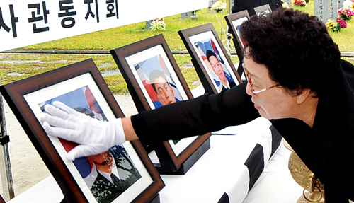 2011년 6월 25일 국립대전현충원에서 제2연평해전 9주기 추모식에서 유가족들이 고인의 영정사진을 어루만지고 있다.
