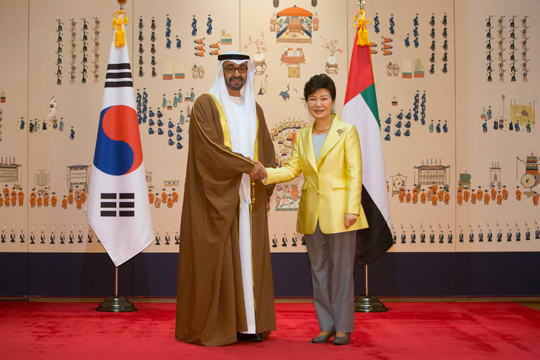 박근혜 대통령이 27일 오후 청와대에서 모하메드 빈 자이드 알 나흐얀 아랍에미리트(UAE) 아부다비 왕세제를 접견, 양국 국기 앞에서 기념촬영하며 악수하고 있다. (사진=청와대)