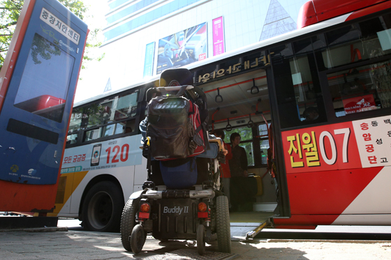 국토교통부는 2021년까지 전국 시내버스 100대 중 42대를 저상버스로 바꾸고 농어촌 지역에는 중형 저상버스를 운행해 교통약자의 이동권을 보다 확대한다고 14일 밝혔다. 또한 휠체어 사용자가 탑승 가능한 고속·시외버스 모델이 개발돼 편리한 교통 환경이 시내·외에 조성될 계획이다. 사진은 광주 동구 충장치안센터 버스정류장에서 전동휠체어를 탄 장애인이 저상버스에 오를 준비하고 있다.<저작권자(c) 연합뉴스, 무단 전재-재배포 금지> 