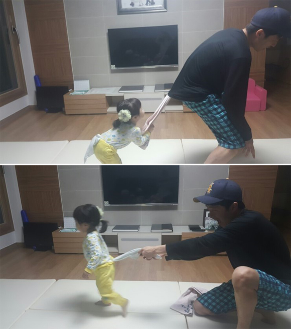 집안에서 쉽게 활용할 수 있는 수건으로 꼬리잡기 놀이 중인 김태규씨와 딸 꽃송이의 모습.