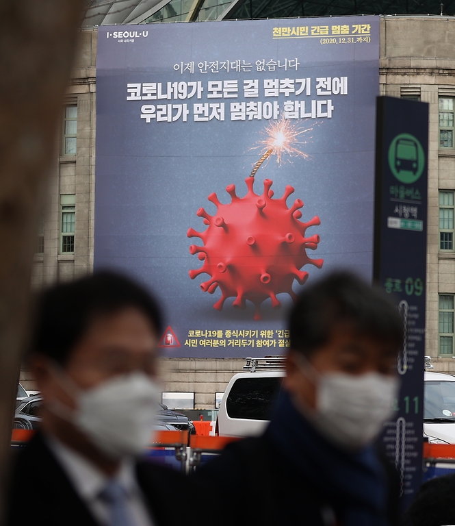 25일 오전 서울도서관 외벽에 12월 31일까지 코로나19 확산 방지를 위한 긴급멈춤 기간을 알리는 대형 현수막이 설치되어 있다