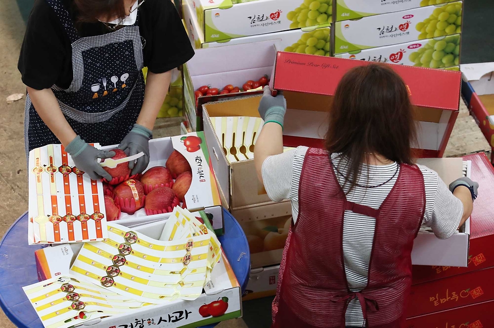 <p>추석 연휴를 이틀 앞둔 17일 오전 대전 유성구 노은농수산물도매시장 내 청과물시장에서 상인들이 과일 상자를 포장하고 있다.</p>