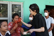김건희 여사가 12일(현지시간) 캄보디아 프놈펜에서 선천성 심장질환을 앓고 있는 14세 아동의 집을 찾아 가족의 눈물을 닦아주고 있다. 