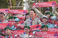 윤석열 대통령이 29일 서울 용산구 대통령실 청사 파인그라스 정원에서 열린 한국스카우트연맹 명예총재 추대식에서 지진 피해로 어려움에 처한 튀르키예 스카우트 대원들을 응원하는 퍼포먼스를 하고 있다.