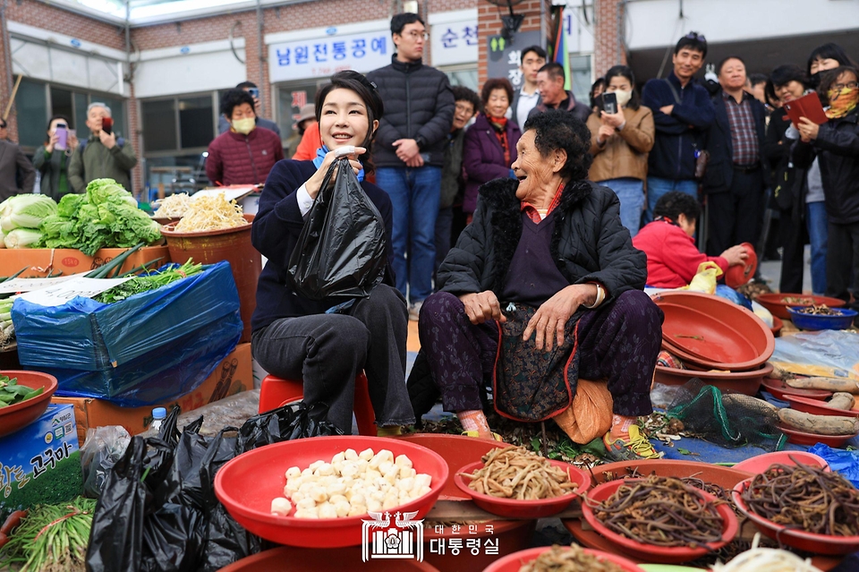 김건희 여사가 7일 전남 순천시 아랫장 전통시장을 방문해 농산물을 구매하고 있다.