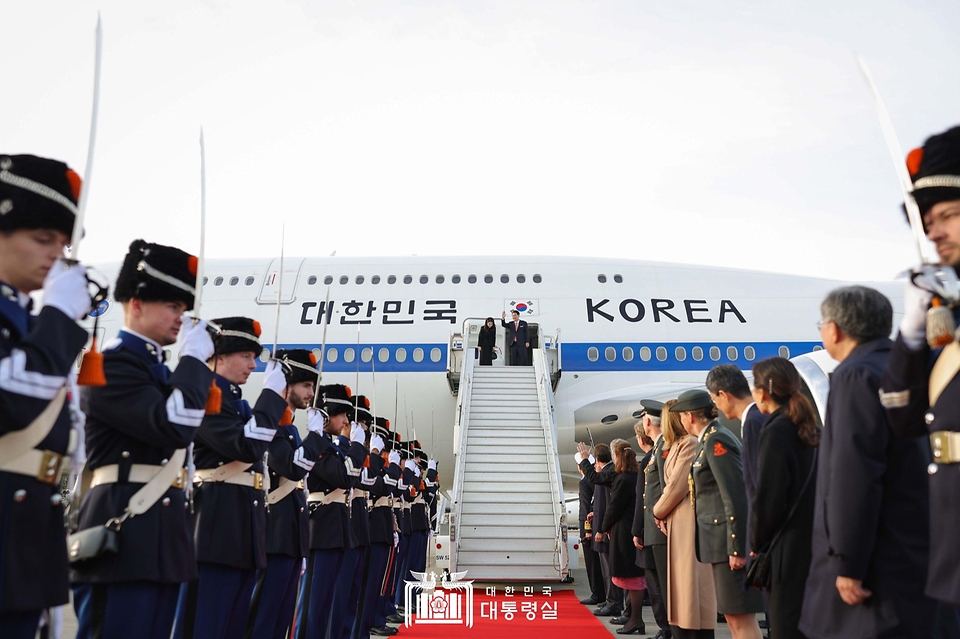 윤석열 대통령과 김건희 여사가 14일(현지시간) 네덜란드 암스테르담 스히폴 공항에서 귀국하기 전 환송객들에게 손을 들어 인사하고 있다.