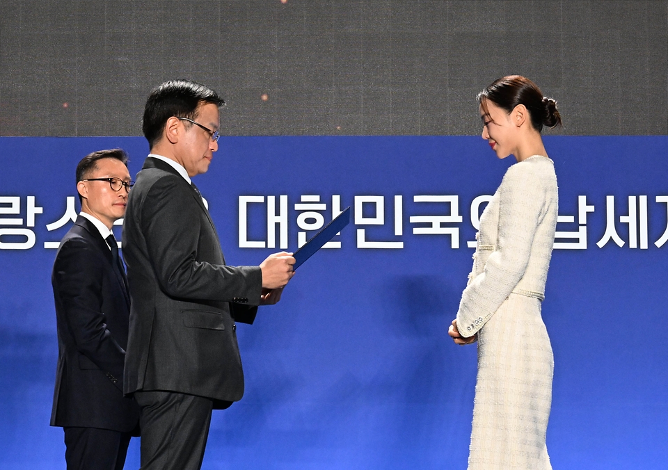 최상목 경제부총리 겸 기획재정부 장관이 4일 서울 중구 동대문디자인플라자(DDP)에서 열린 ‘제58회 납세자의 날 기념식’에서 배우 신혜선에게 대통령 표창을 수여하고 있다. 