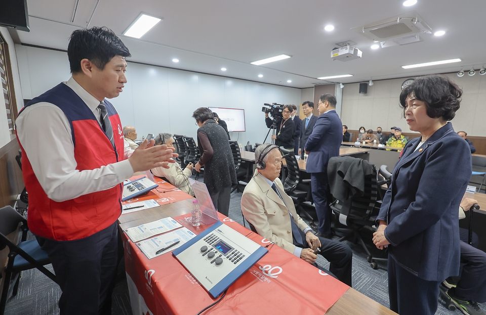 강정애 국가보훈부 장관이 18일 오후 서울시 용산구 서울지방보훈청에서 열린 국가보훈부-한국수출입은행-사랑의달팽이 국가유공자 보청기 지원사업 협약식에 참석해 협약식 이후 참전유공자에게 직접 맞춤형 청력검사 받는 것을 도와드리고 있다.