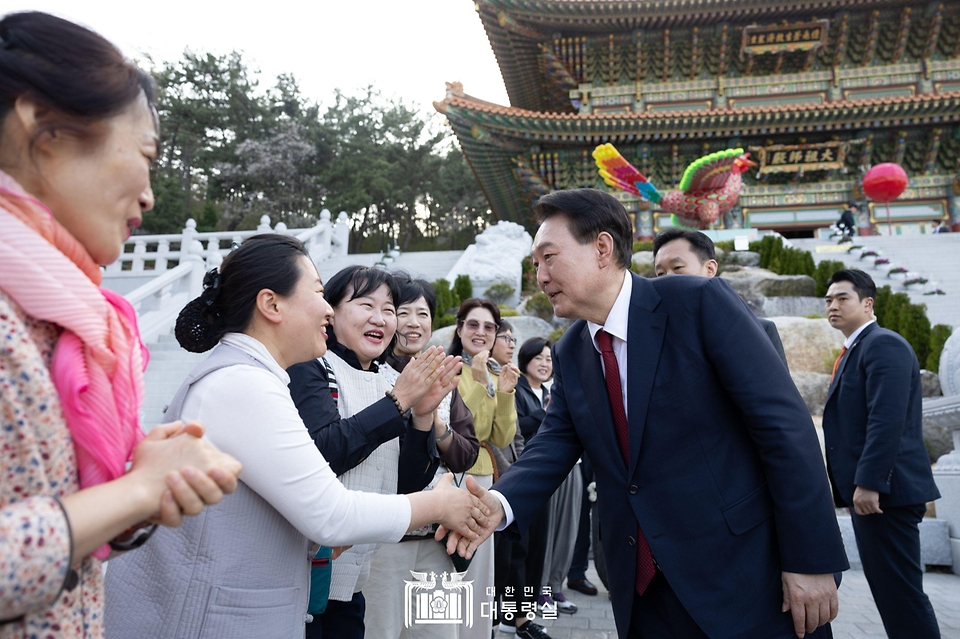 윤석열 대통령이 5일 부산시 부산진구 삼광사를 찾아 대조사전에서 환영 나온 신도들과 인사하고 있다. 