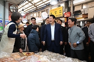 윤석열 대통령이 10일 서울 서대문구 영천시장을 찾아 한 점포에서 상인과 인사하고 있다. 