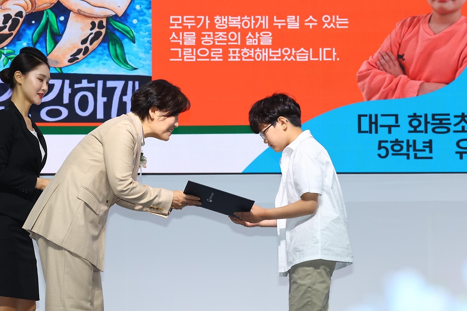 송미령 농림축산식품부 장관이 10일 경기 고양시 고양국제꽃박람회장에서 열린 2024년 ‘세계 식물건강의 날’ 기념식에서 어린이 포스터 공모전 수상자에게 상장을 전달하고 있다.