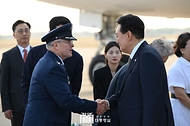 윤석열 대통령이 10일(현지시간) 미국 워싱턴DC 인근 앤드루스 공군기지에 도착해 공군 1호기에서 내린 뒤 영접 나온 앤드루스 기지 영접관과 인사하고 있다. 