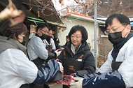 오유경 처장이 20일 청주 독거노인 가정에 사랑의 연탄배달 자원봉사를 마친 후 참석자들과 기념촬영을 하고 있다.