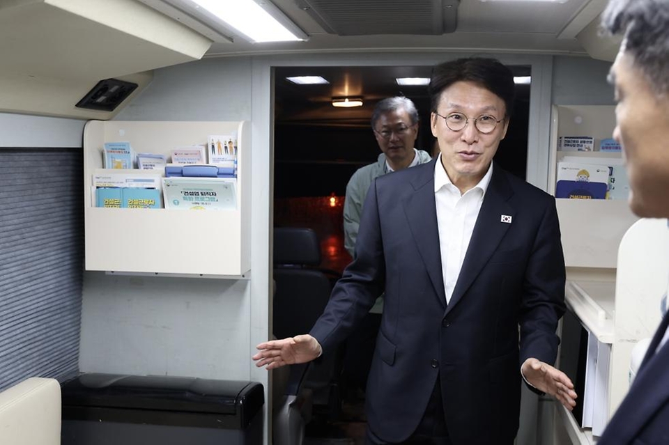 김민석 국무총리가 10일 구로구 남구로 새벽인력시장을 찾아 '종합지원 이동 상담버스'를 둘러보고 근로자들에게 떡을 나눠주고 있다.