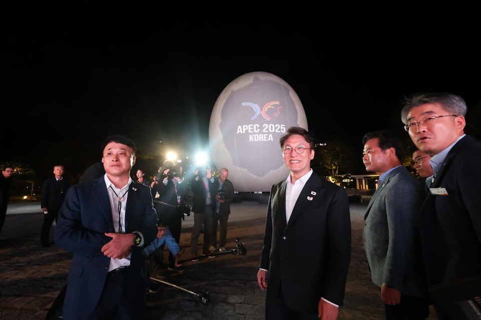 김민석 국무총리가 23일 경상북도 경주시 보문단지 호반 광장에 설치된 신라의 탄생 신화인 '알에서 태어난 혁거세'를 모티브로 제작한 높이 15m의 대형 알 모양의 APEC 상징조형물에 미디어아트가 진행되는 것을 살펴보고 있다.