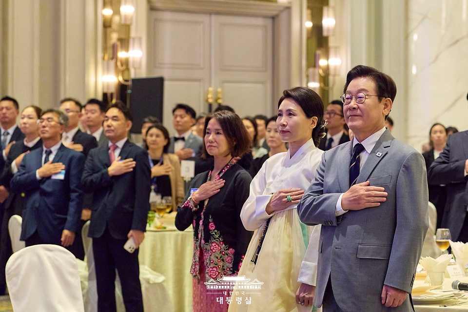 이재명 대통령과 김혜경 여사가 26일(현지시간) 말레이시아 쿠알라룸푸르 한 호텔에서 열린 동포 간담회에서 참석자들과 국민의례를 하고 있다.