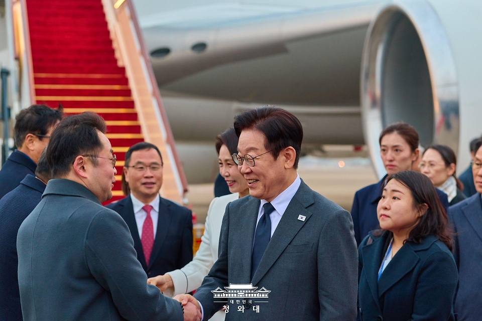 중국을 국빈방문 중인 이재명 대통령과 김혜경 여사가 1월 6일(현지 시간) 상하이 푸동 공항에서 영접 인사들과 악수하고 있다.