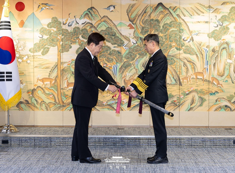 이재명 대통령이 3월 27일 서울 용산 국방부에서 김경률 신임 해군참모총장에게 삼정검 수치를 수여하고 있다.