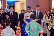이재명 대통령과 김혜경 여사가 7월 29일(현지 시간) 칠레 산티아고 한 호텔에서 열린 동포 만찬간담회에서 화동과 인사하고 있다.