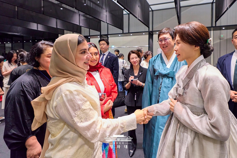김혜경 여사가 8월 14일 서울 동대문디자인플라자(DDP)에서 열린 2026 한복상점 전시회에서 외국인들과 대화하고 있다.