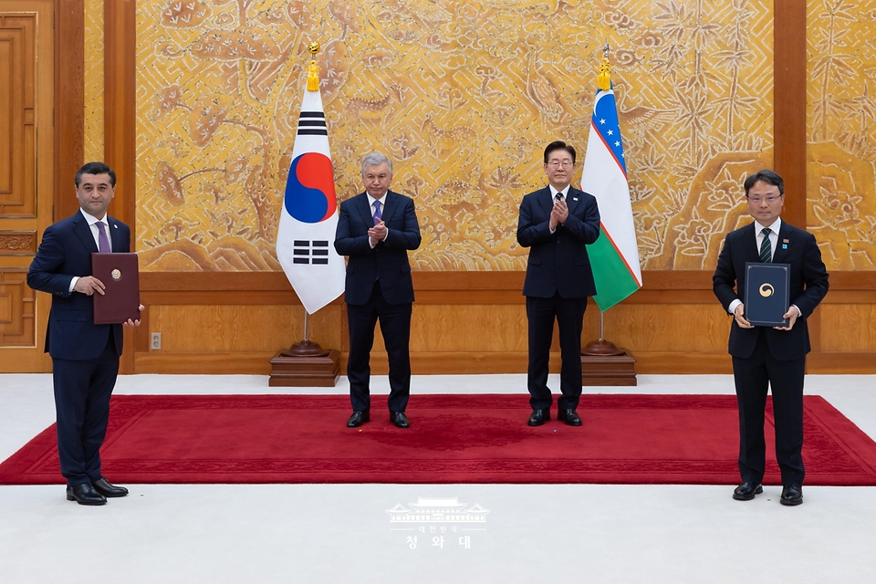 박은식 산림청장과 바흐티요르 사이도프 우즈베키스탄 외교부장관이 9월 14일 청와대에서 이재명 대통령과 샤브카트 미르지요예프 대통령이 임석한 가운데 디지털 산림복원 및 기후 대응 협력에 관한 양해각서 문건을 교환한 뒤 기념 촬영을 하고 있다.