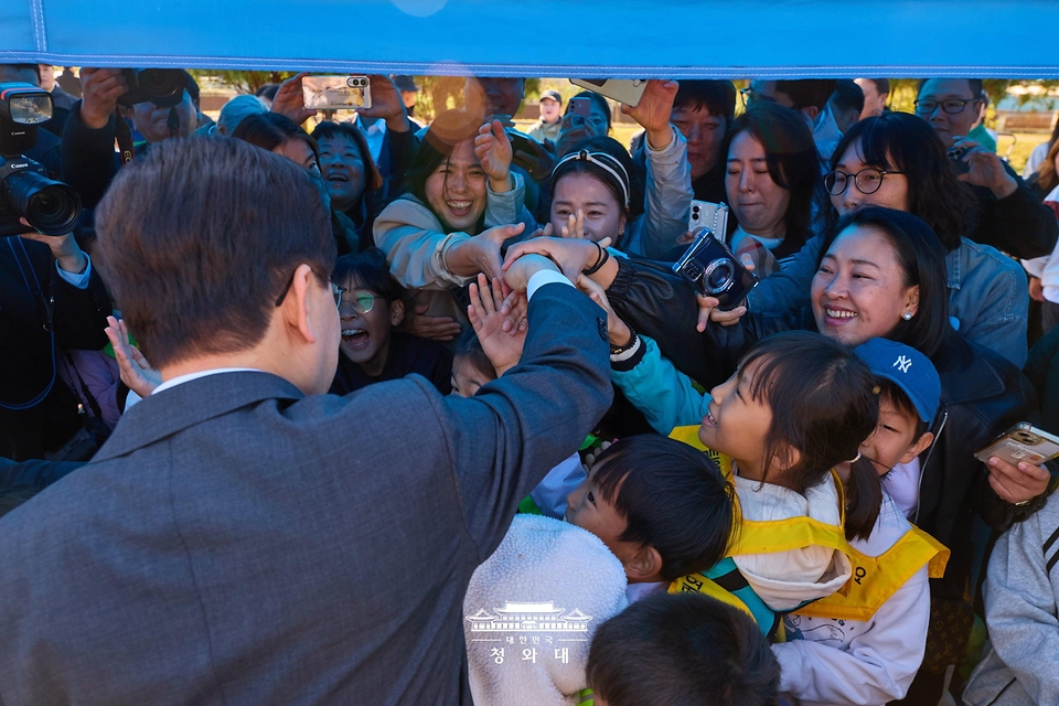 이재명 대통령이 10월 22일 전북 익산 왕궁초등학교에서 열린 가을 체육한마당에서 학생들과 인사하고 있다.