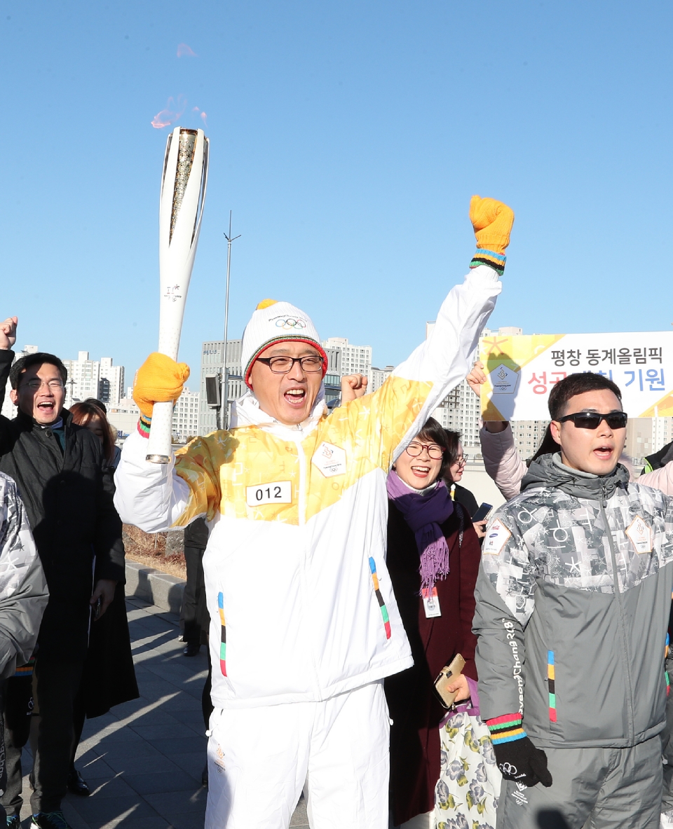 12월 13일 오후 세종특별자치시 정부세종청사 옥상정원에서 주자로 나선  세종청사에서 일하는 공무원들이 직장 선후배 및 기족들의 응원을 받으며 ‘2018 평창동계올림픽 성화 봉송’을 하고 있다. 이날 1동 국무총리실에서 시작해서 15동 문화체육관광부 옥상정원에서 성화봉송을 마무리하며 19명의 주자들이 기념촬영을 했다.
