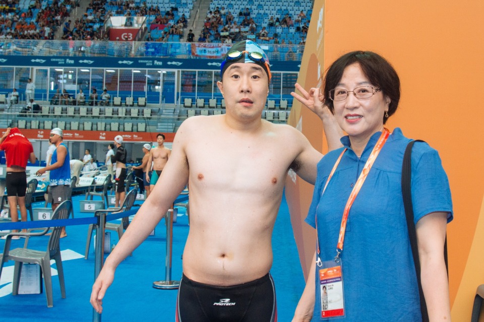 자폐 장애 1급인 이동현 씨(29·광주시 동구 학동)는 2019 광주 세계 마스터스 수영선수권대회에서 경영 25~29세 그룹 자유형 100m(13일)와 접영 50m(14일), 접영 100m(15일) 등 3개 종목에 출전한다.
<br/>
13일 오후 남부대 시립 국제수영장 주 경기장에서 펼쳐진 남자 자유형 100m에서 이동현 씨는 역주 끝에 50m를 30초27, 100m를 1분 4초 50의 기록으로 조 6명 중 3위로 결승 패드를 찍었다. 관중석에선 이동현 씨의 아름다운 도전을 환호와 박수로 격려했다. 사진은 어머니 정순희씨와 이동현씨. 