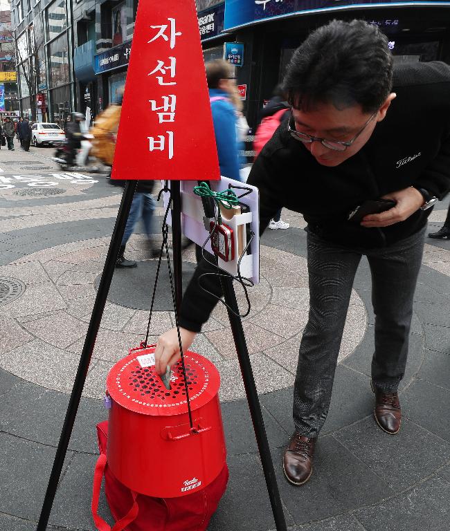 11일 구세군사관학교 학생이 서울 명동거리에 설치된 자선냄비 앞에서 모금 봉사활동을 펼치고 있다. 모금기간은 올해 12월 31일까지이며 전국 17개 시,도에 353개의 자선냄비가 설치되어 모금활동을 펼칠 예정이다.