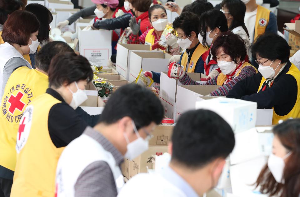 27일 서울 성동구 대한적십자사 서울특별시지사에서 대한적십자 직원 및 봉사자들이 코로나19 대응 서울시내 재난취약계층에게 전달할 긴급구호품을 제작하고 있다. 이날 주부식 14종 및 마스크 9개가 들어간 900박스를 제작했으며 3월 25일부터 오늘까지 5,000박스 제작을 완료할 예정이다.