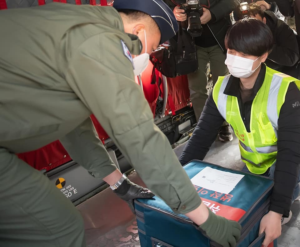 19일 오후 경기도 이천시 특수전사령부 헬기장에서 열린 ‘백신 유통 제2차 범정부 통합 모의훈련’에서 운송 관계자가 치누크헬기(CH-47D)에 백신 모형을 운반하고 있다.