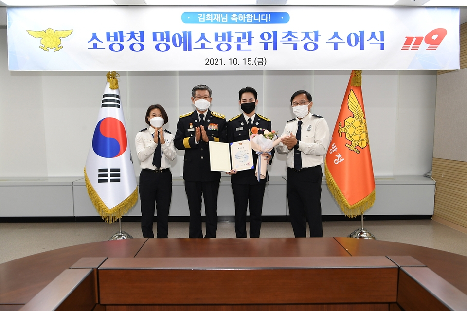 신열우 소방청장이 15일 오후 세종시 소방청에서 명예소방관으로 위촉된 가수 김희재 씨와 함께 기념촬영을 하고 있다.