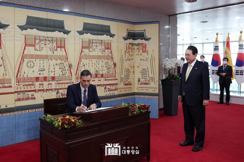 윤석열 대통령이 18일 서울 용산구 대통령실 청사에서 페드로 산체스 스페인 총리의 방명록 서명을 지켜보고 있다. 