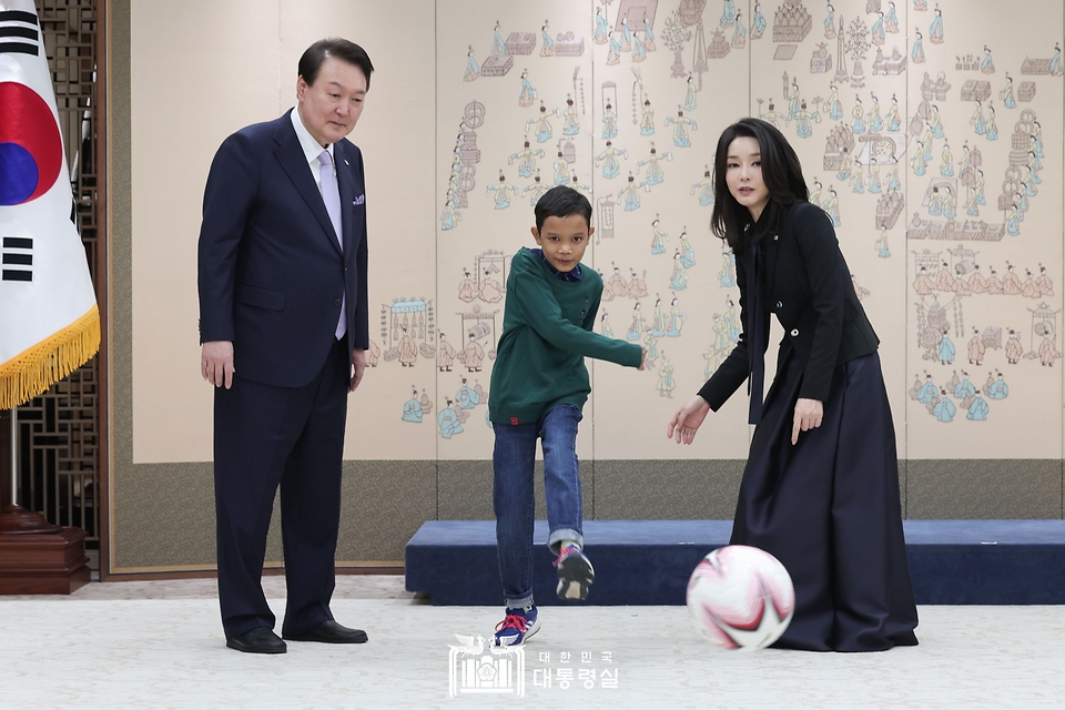 윤석열 대통령과 김건희 여사가 31일 서울 용산 대통령실 청사에서 심장질환 수술을 받고 회복 중인 캄보디아 소년 로타가 공을 차고 있는 모습을 바라보고 있다.