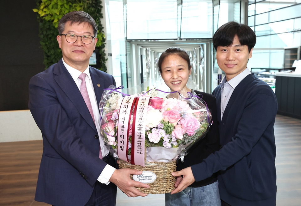 이기일 보건복지부 1차관이 18일 서울 종로구 SK온에서 국내 최초 초산 자연분만 네쌍둥이의 탄생을 축하하며 네쌍둥이의 부모인 송리원, 차지혜 씨에게 꽃바구니를 전달하고 있다.