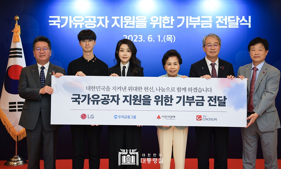 김건희 여사가 1일 서울 중구 사랑의열매 회관에서 열린 ‘국가유공자 지원을 위한 기부금 전달식’에서 참석자들과 기념촬영을 하고 있다.