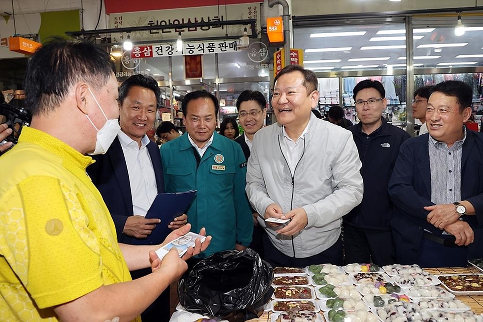이상민 행정안전부 장관이 26일 경기 오산시 오색시장을 방문해 명절 성수품을 구매하며 상인들을 격려하고 있다.