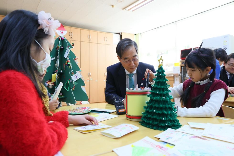 한덕수 국무총리가 22일 경기도 성남시 성남장안초등학교에서 시범 운영 중인 늘봄학교를 방문해 어린이들과 함께 크리스마스 카드를 만들고 있다.