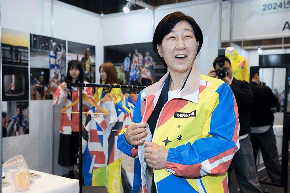 한화진 환경부 장관이 22일 서울 강남구 코엑스에서 열린 ‘2024 기후변화주간’ 개막식에서 홍보부스를 둘러보며 폐현수막으로 만든 옷을 입어보고 있다.