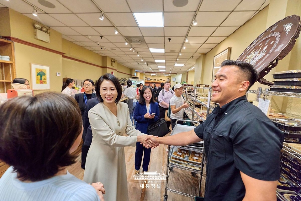 김혜경 여사가 23일(현지시간) 미국 뉴욕 코리아타운 한 상점을 찾아 관계자들과 대화를 하고 있다.