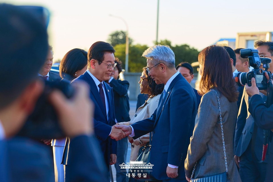 이재명 대통령이 23일(현지 시간) 남아프리카공화국 요하네스버그 국제공항에서 G20 정상회의 참석을 마치고 튀르키예 앙카라로 출발하기 전 양동한 주남아공 대사와 악수하고 있다.