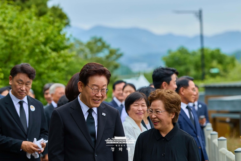 이재명 대통령과 권양숙 여사가 5월 23일 경남 김해 봉하마을 고 노무현 전 대통령 사저 인근에서 대화하며 이동하고 있다.